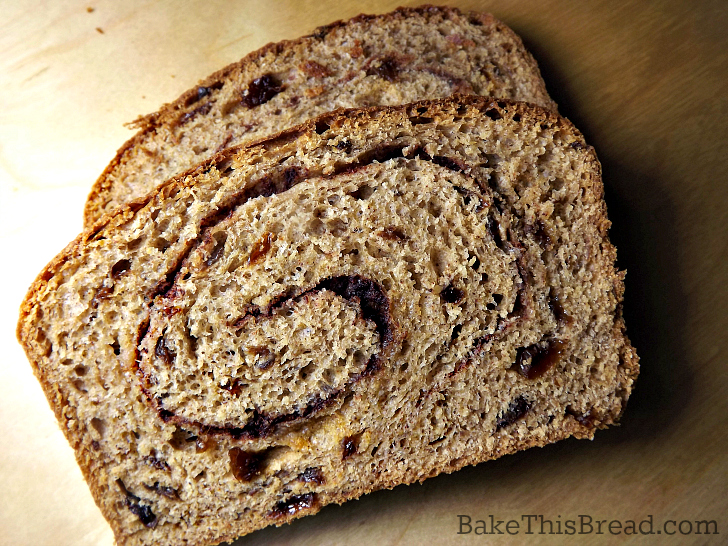 Cinnamon Swirl Bread slices on polished maple by bake this bread