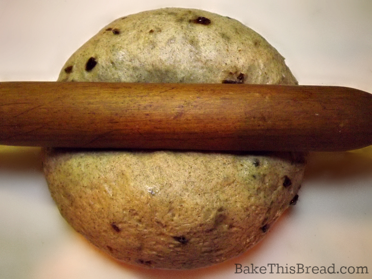 Using a rolling pin to roll cinnamon bread swirl by bake this cake